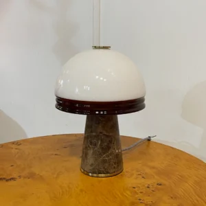 Milano table lamp three quarter angle showing marble texture brass accents and glass diffuser