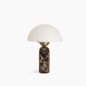 Milano marble table lamp with white frosted glass dome shade and spotted natural marble base, photographed against neutral studio background
