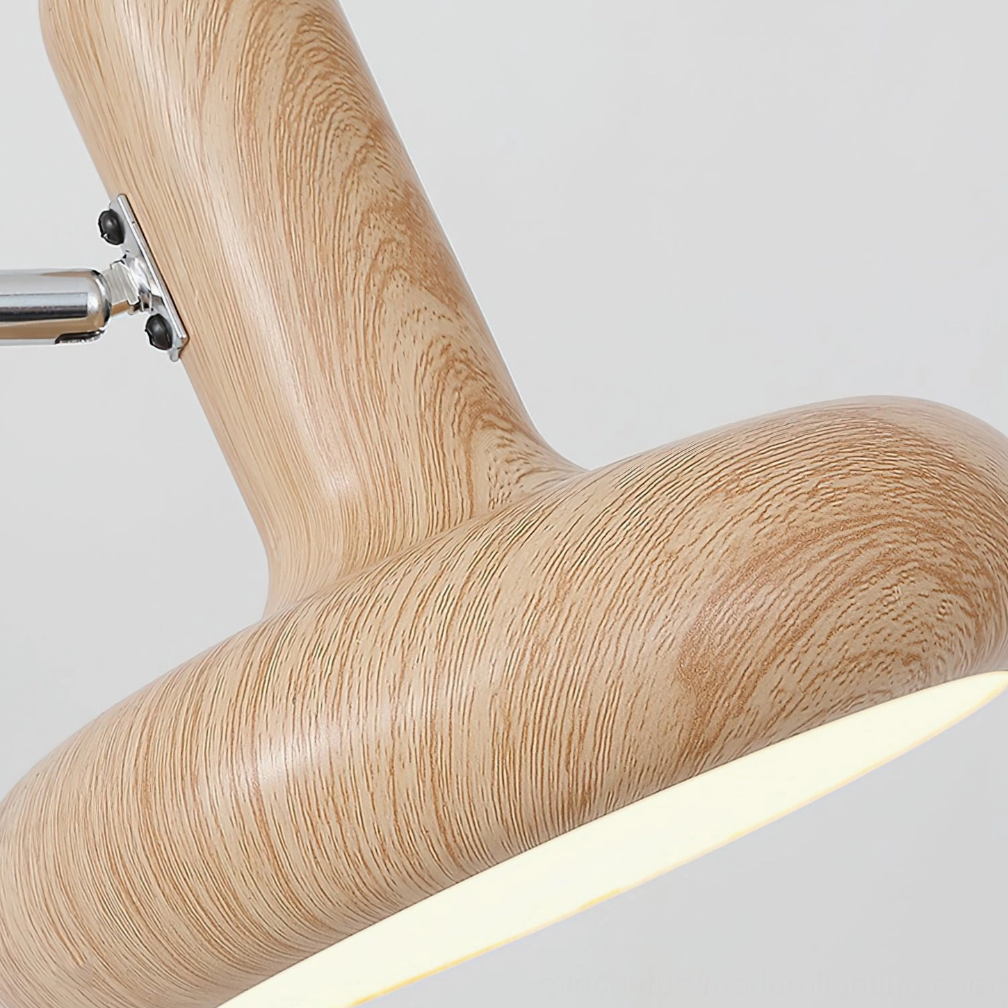Milena wall-mounted swing arm light fixture with chrome metal accents and warm wood finish, architectural detail shot