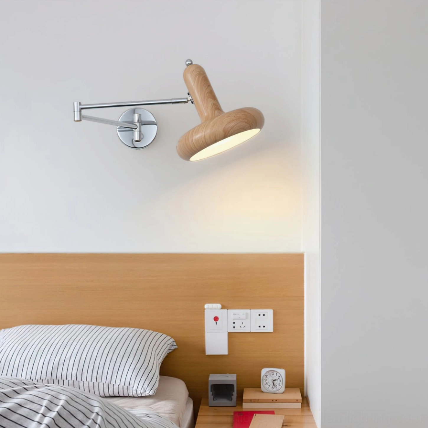 Milena wall-mounted reading sconce with natural light wood finish in Nordic minimalist bedroom with striped bedding