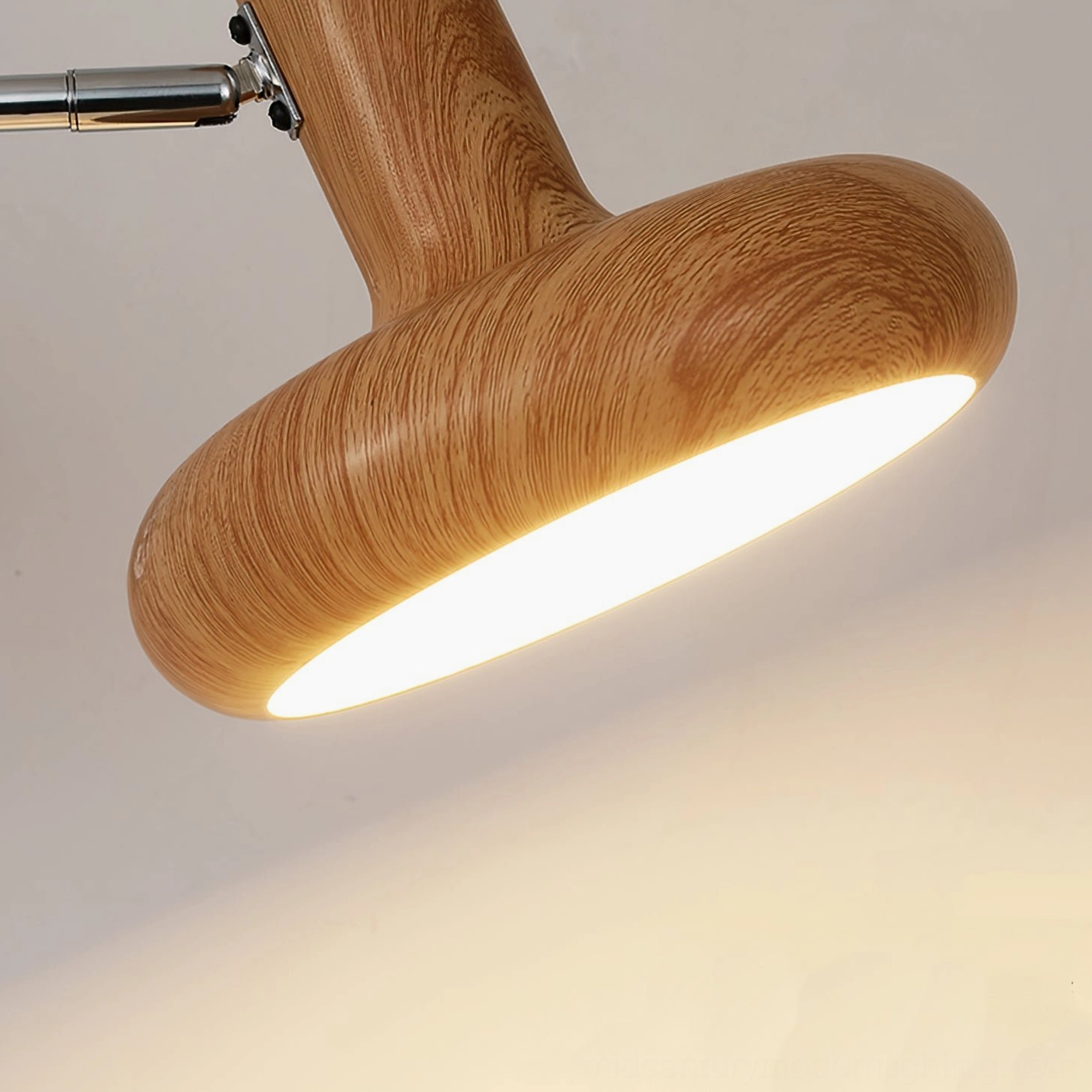 Milena contemporary swing arm wall sconce installed in Scandinavian-style bedroom with warm lighting and natural wood tones