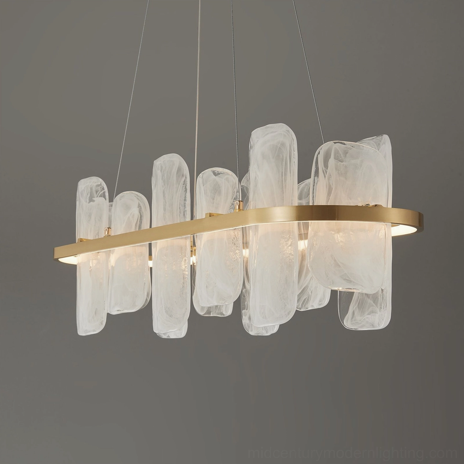 Angled view of oval glass chandelier showing brushed brass frame and thin suspension wire details