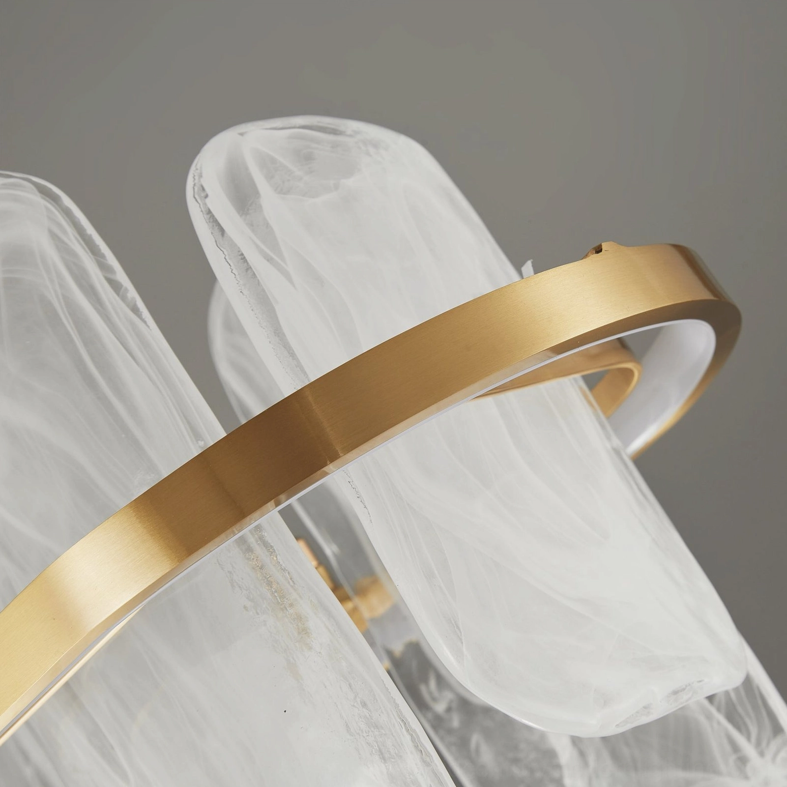 Mille oval glass chandelier product photography highlighting architectural brass framework and glass elements