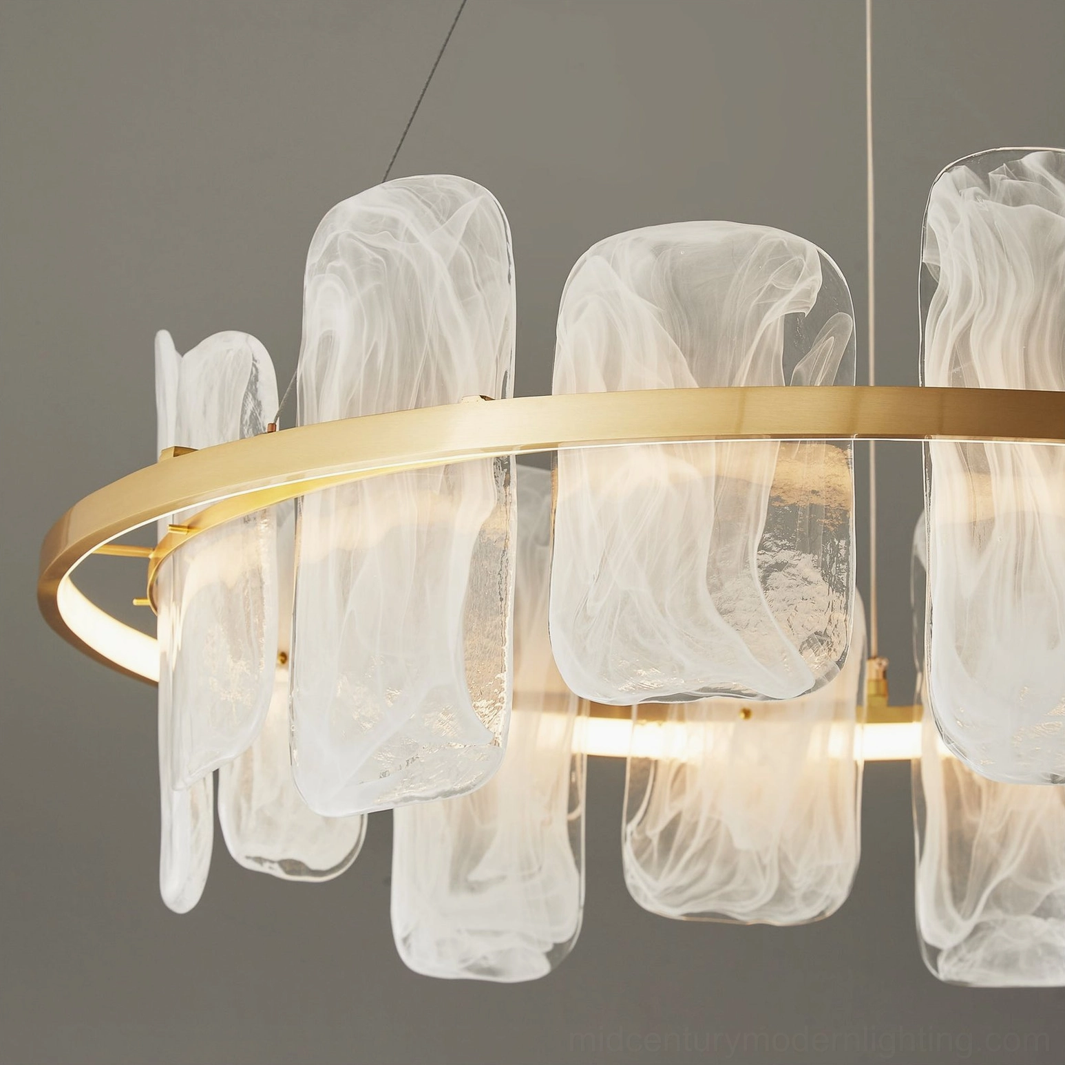 Close-up detail of Mille Round Glass Chandelier brass ring and textured glass pendants