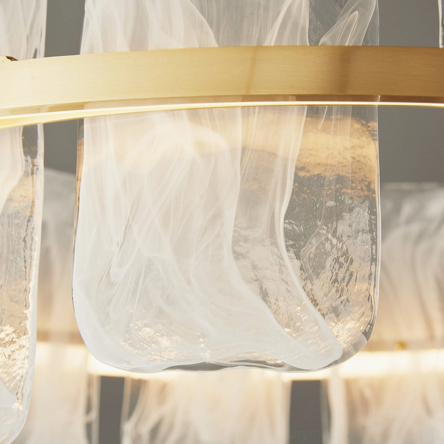 Macro view of Mille Round Glass Chandelier cloud-like wavy glass texture and brass hardware