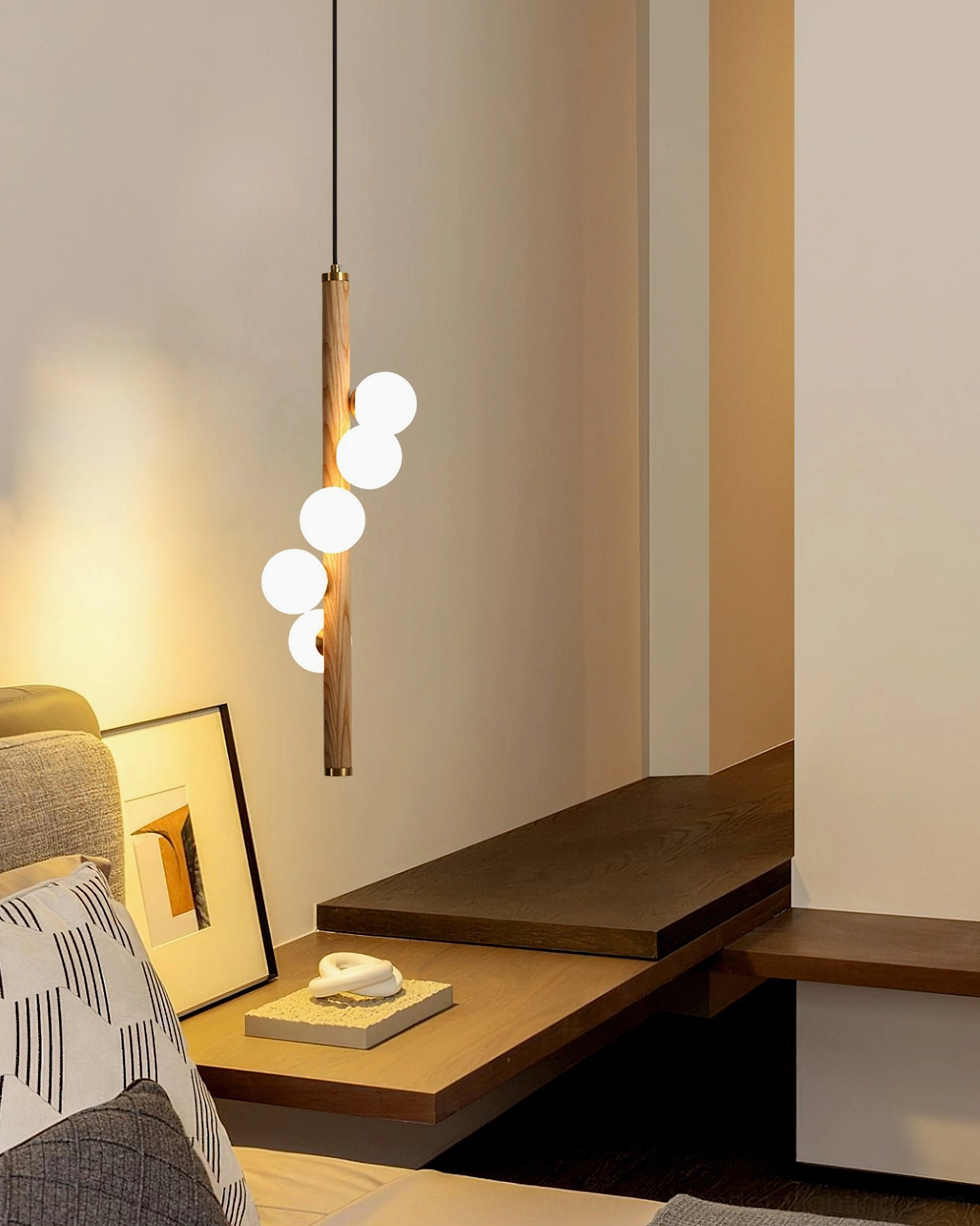 Single Miller pendant above bedroom study area with four lit frosted glass bulbs, minimalist bedroom decor