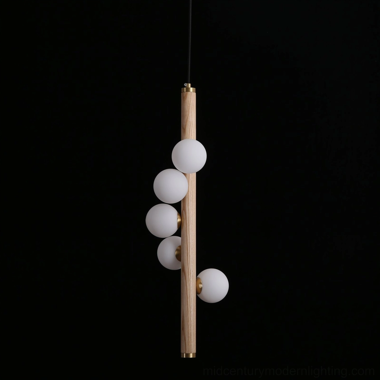 Miller pendant light in contemporary living space, warm glow from frosted glass orbs above seating area