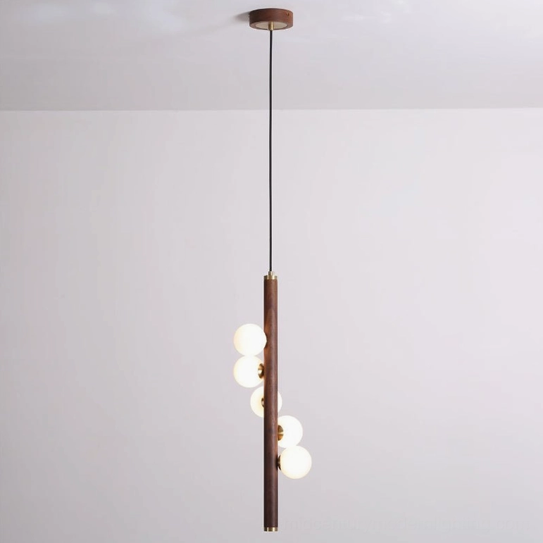 Miller pendant light bottom-up view, dark walnut wood rod with frosted glass orbs, studio background