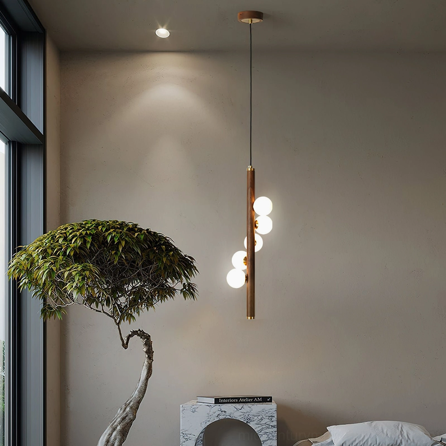 Single Miller wooden pendant in minimalist bedroom nook with three lit glass orbs and potted bonsai decoration
