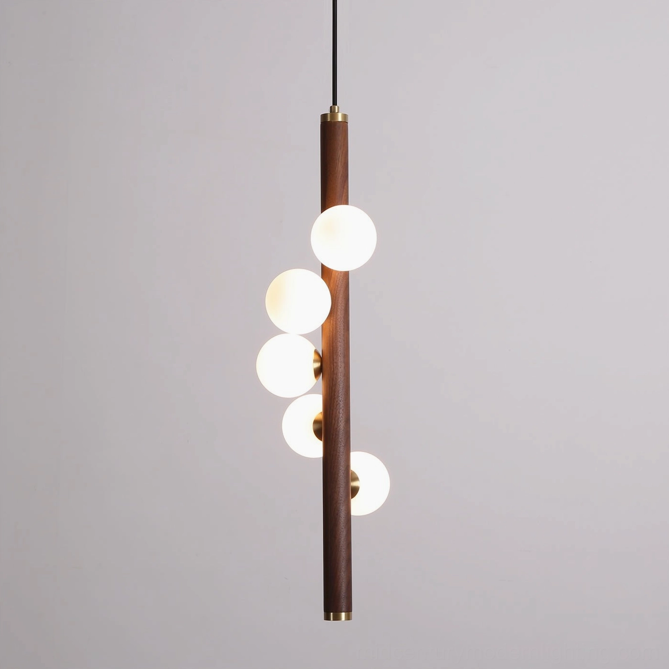 Miller pendant light installation view, warm illumination from frosted glass orbs in modern interior