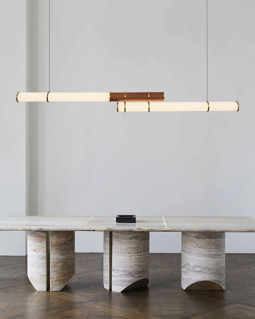 Mini Endless Double linear pendant installed above travertine dining table in modern warm contemporary dining room