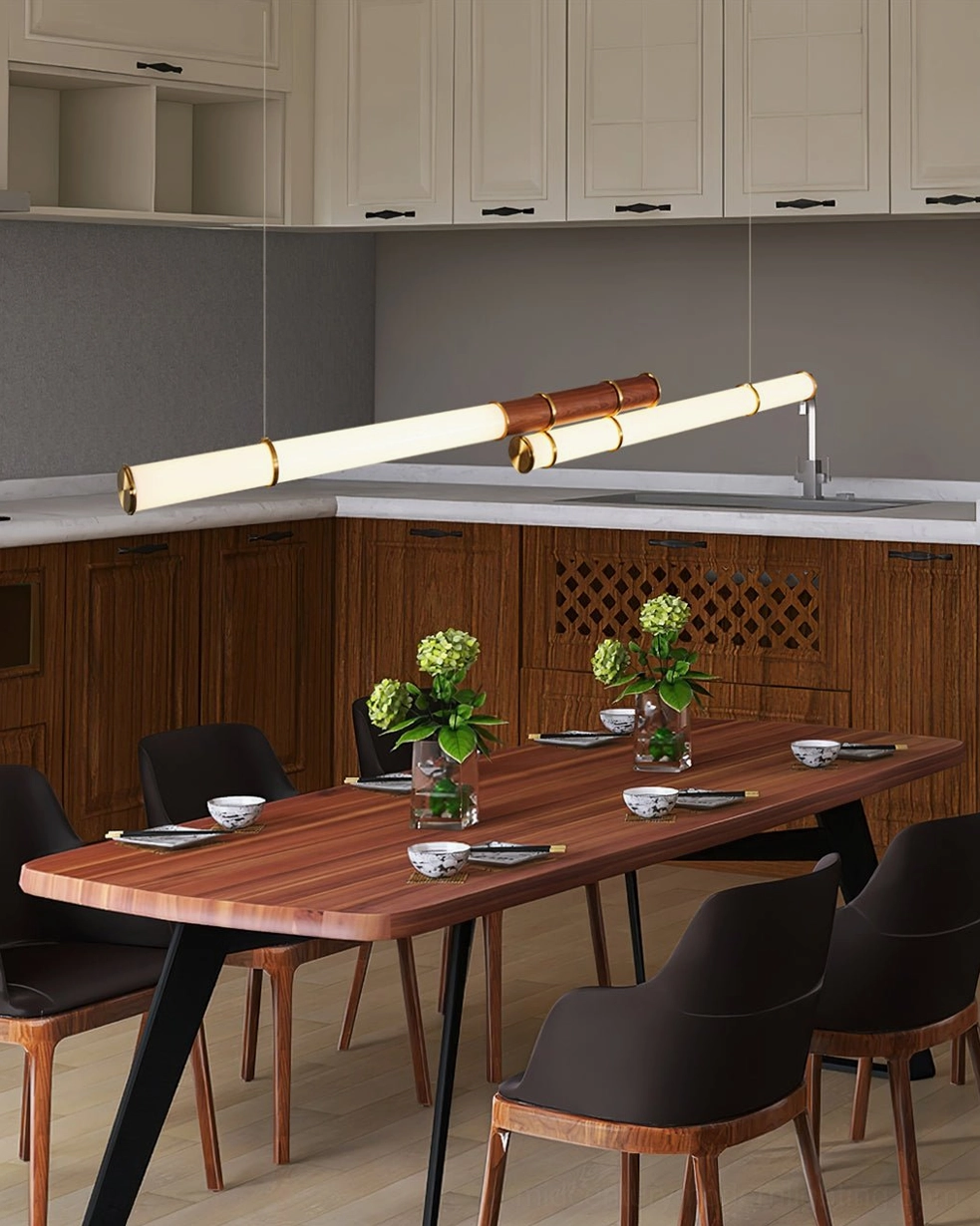 Kitchen dining area with Mini Endless Double linear pendant mounted above long wooden dining table and cabinetry
