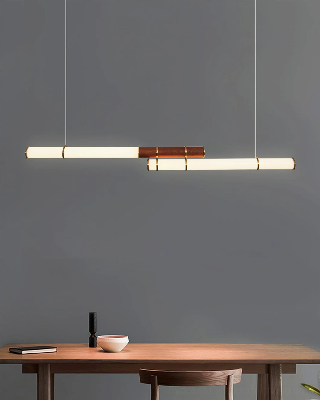 Mini Endless Double pendant light mounted above wooden console table in minimalist studio dining nook setting