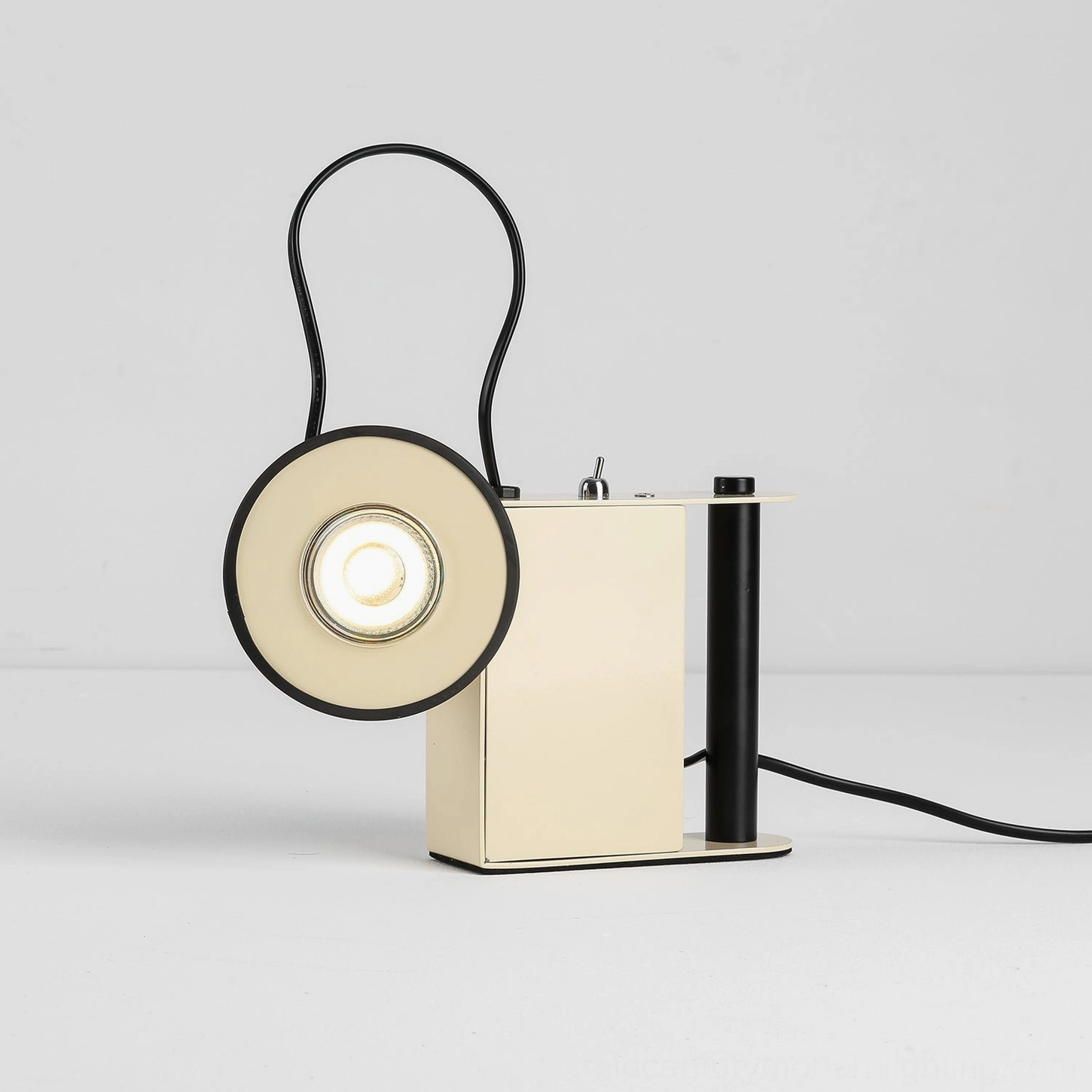 Beige cream Minibox magnetic spotlight table lamp, studio photography, postmodern minimalist design aesthetic