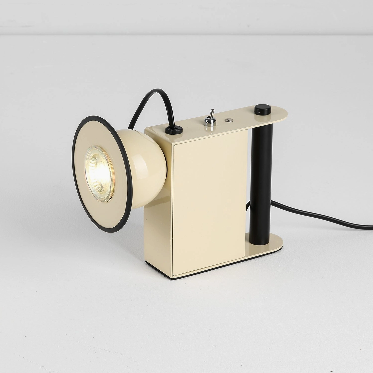 Minibox table lamp in cream beige, three-quarter angle, unlit spotlight head, studio photography, postmodern design form