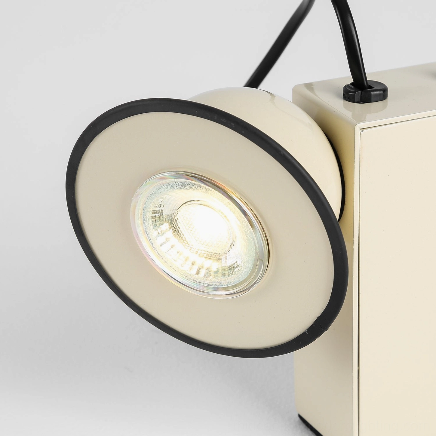 Minibox black compact table lamp, front angle showing enameled steel body and exposed toggle control