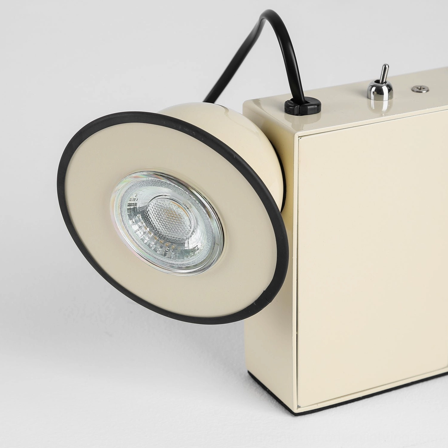 Black Minibox table lamp, three-quarter angle emphasizing sculptural industrial design and cylindrical handle