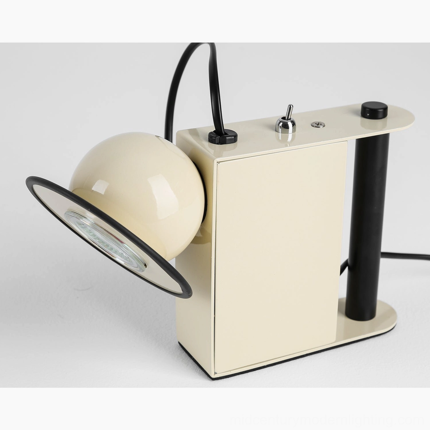 Black Minibox postmodern table lamp, side view with unlit spotlight head, studio backdrop