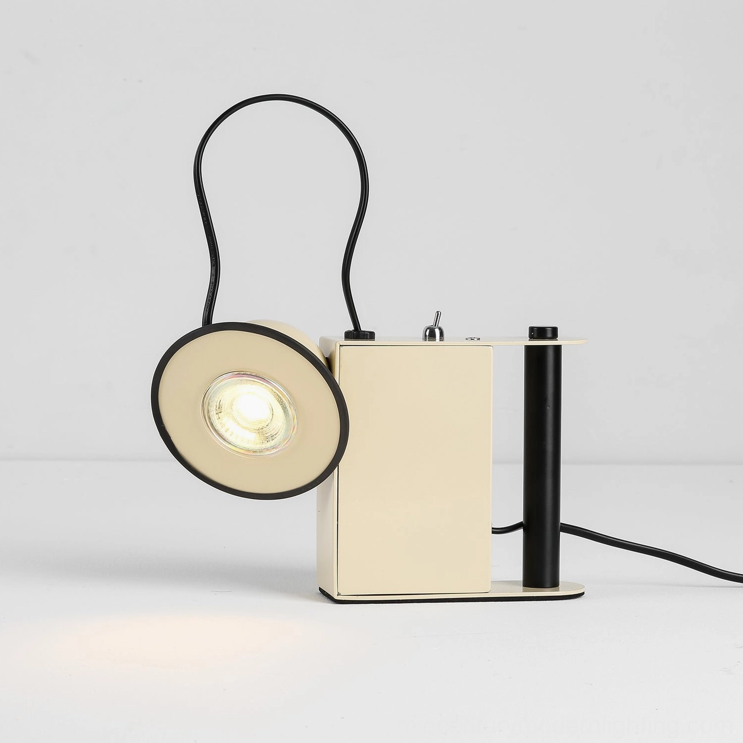 Minibox table lamp in cream, side-angle view with unlit form, geometric metal construction studio shot