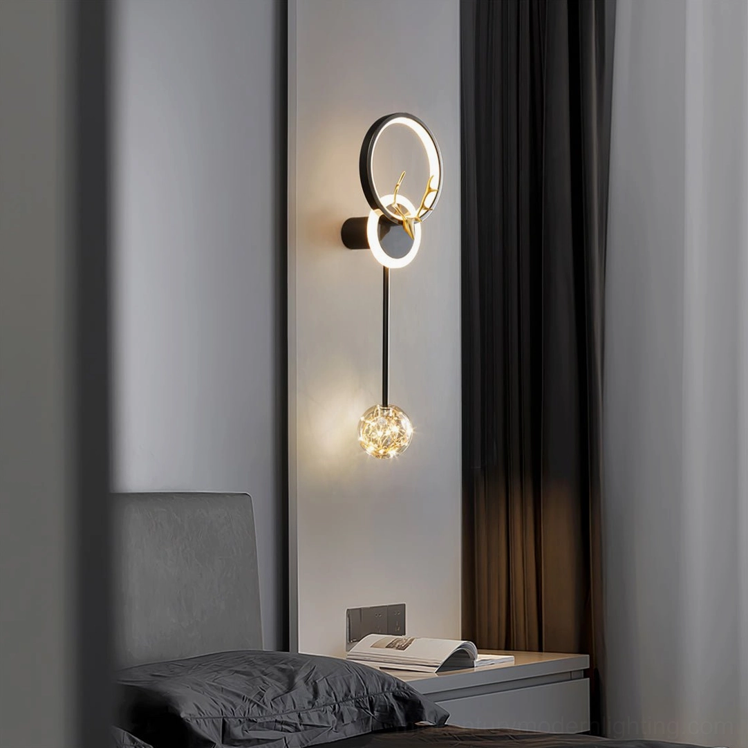 Minimalist black and gold antler wall lamp with crystal glass ball pendant casting warm glow