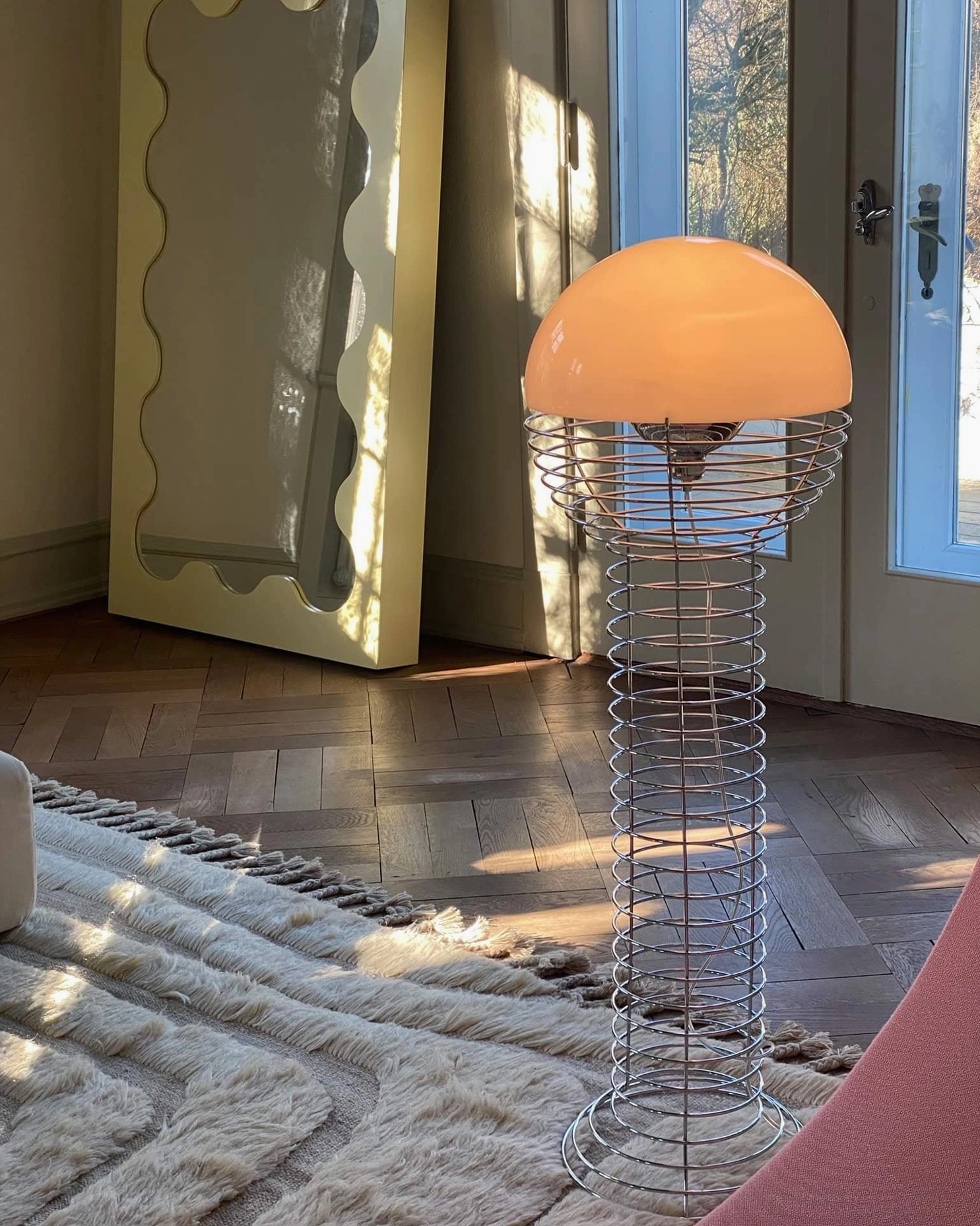 Minimalist chrome wire floor lamp with white hemispherical shade, sleek mid-century modern design