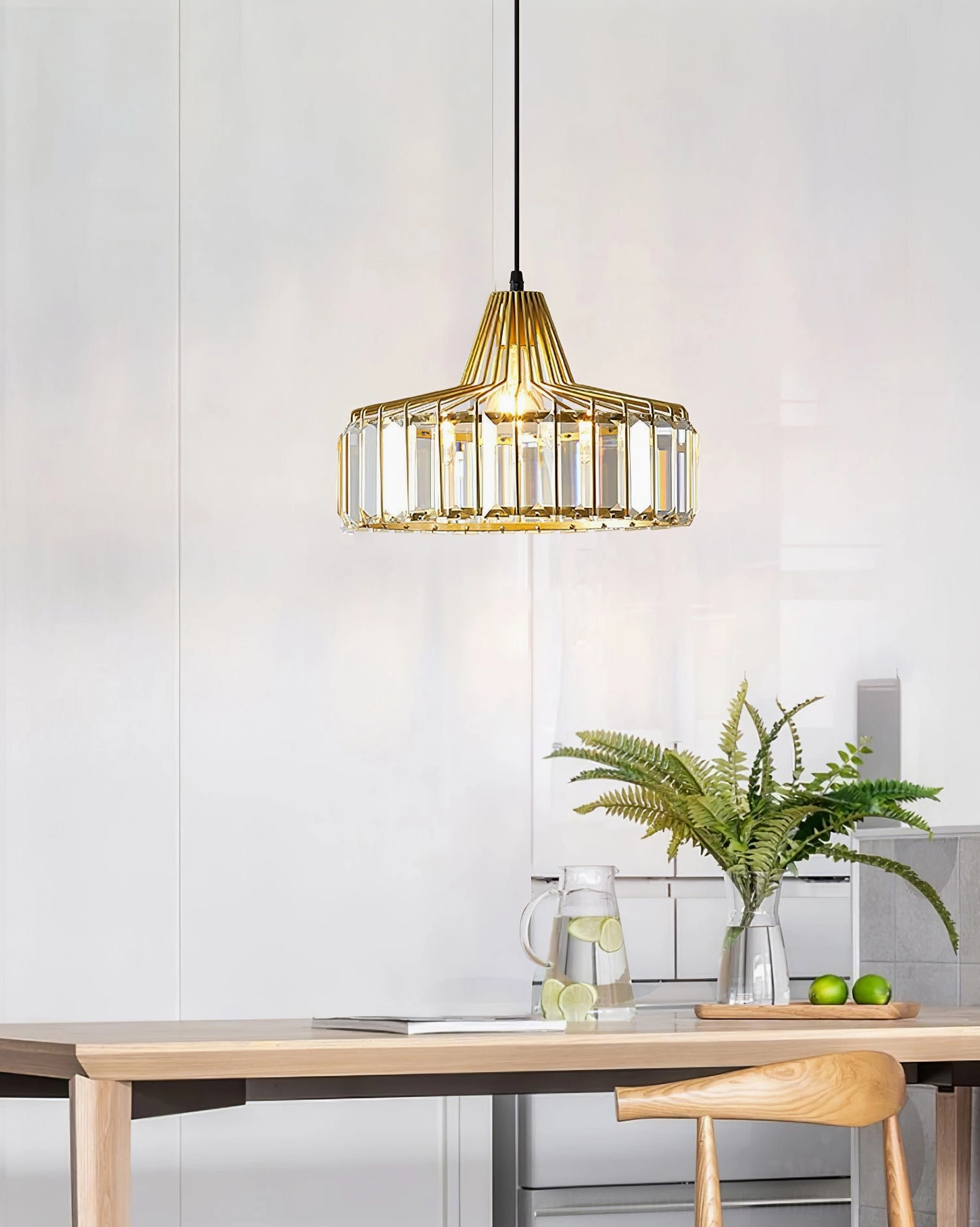 Minimalist crystal pendant light with clean metal framework and crystalline embellishments