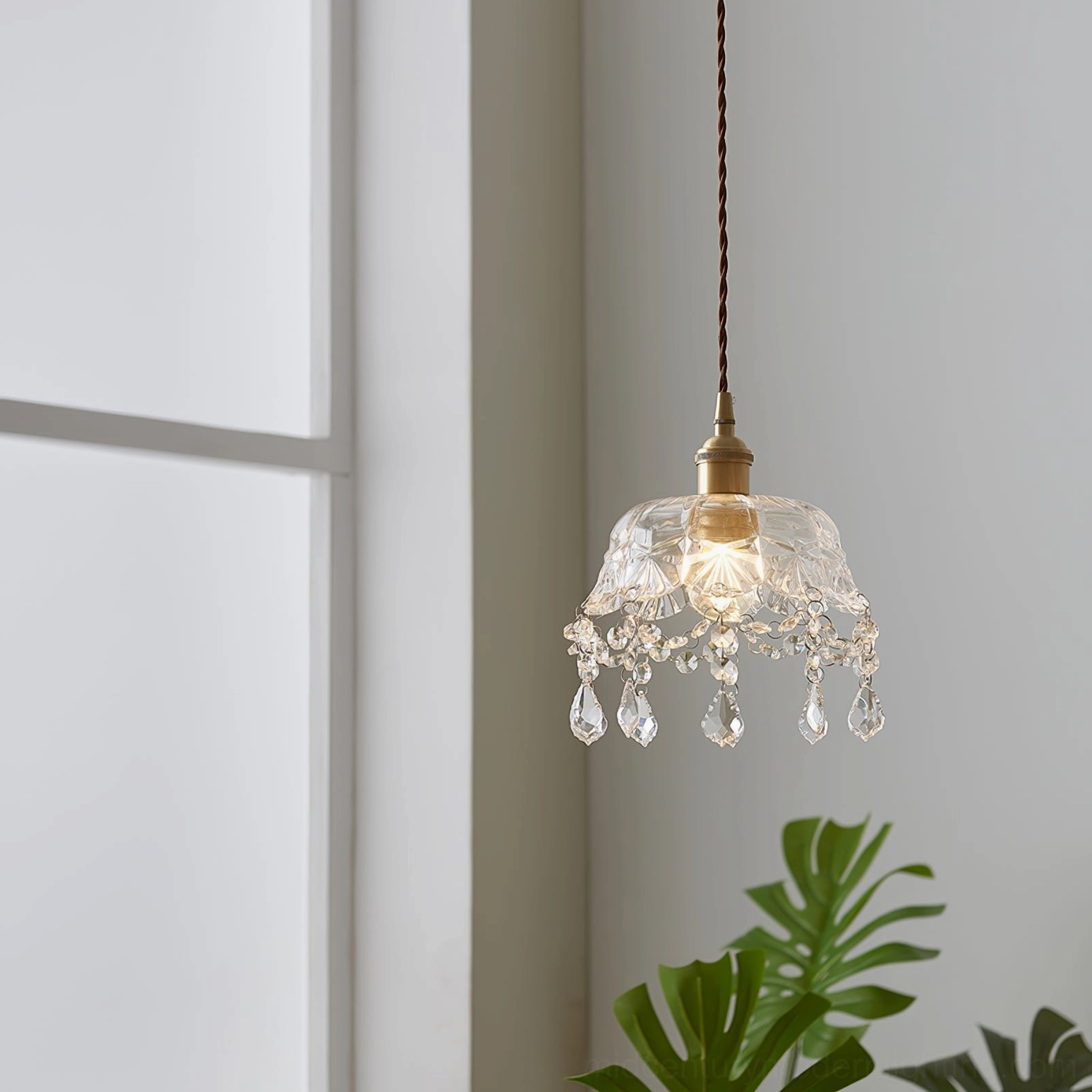 Crystal glass pendant light in minimalist white interior with potted plants, modern home decor