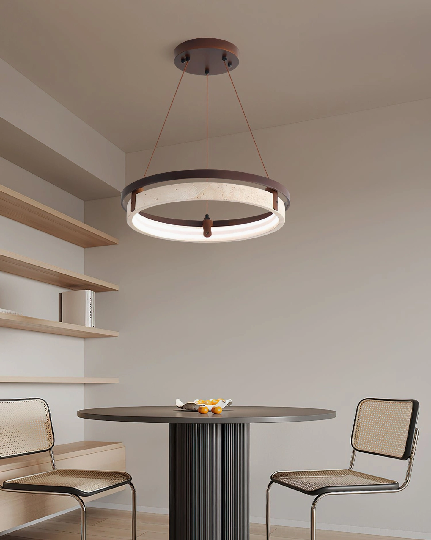 Minimalist dining nook with travertine pendant lamp, round table and rattan chairs in scandinavian interior design
