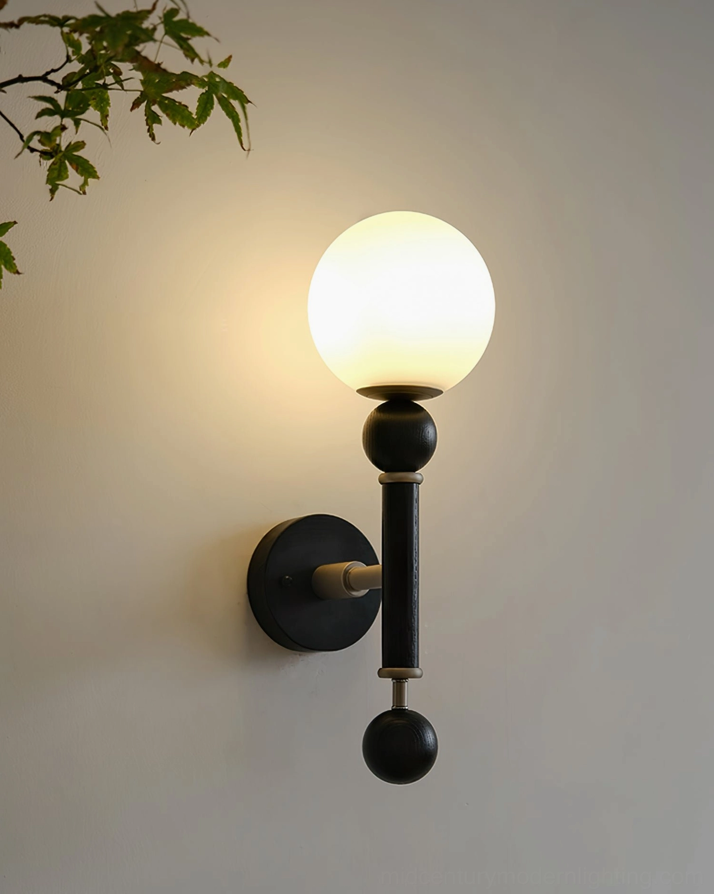 Minimalist globe wall sconce with frosted glass shade in contemporary interior setting