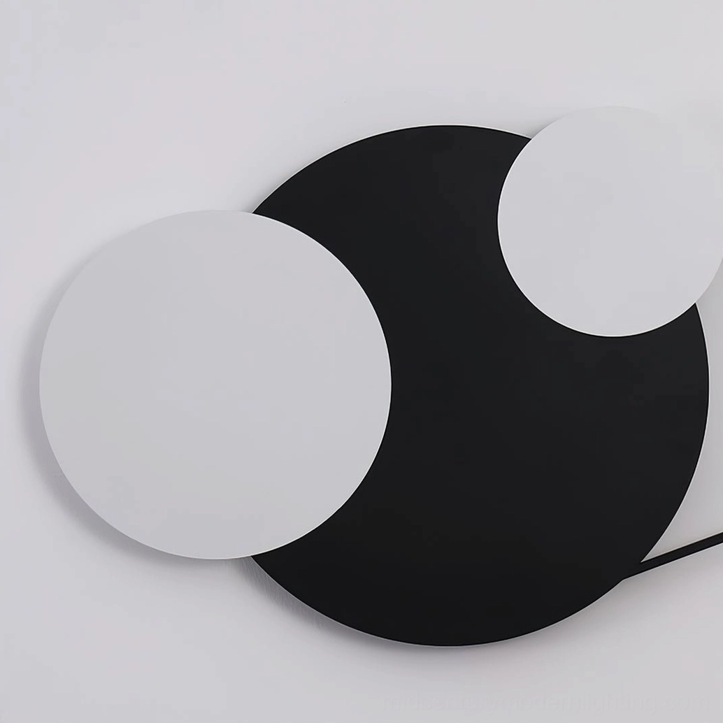 Contemporary minimalist wall installation with Vertical Trio geometric lamp in black and sand white finish