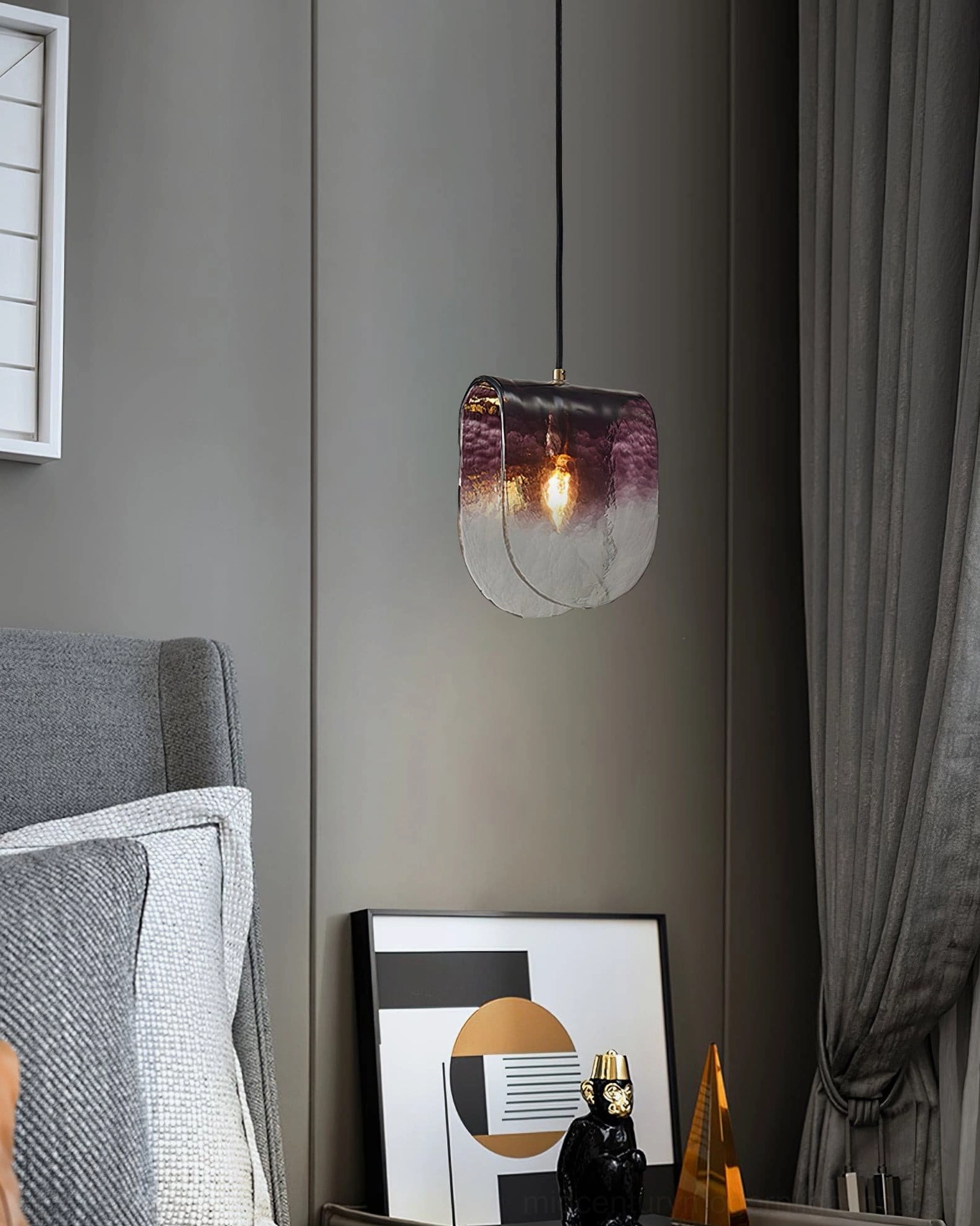 Minimalist pendant light design with organic glass texture and industrial metal suspension