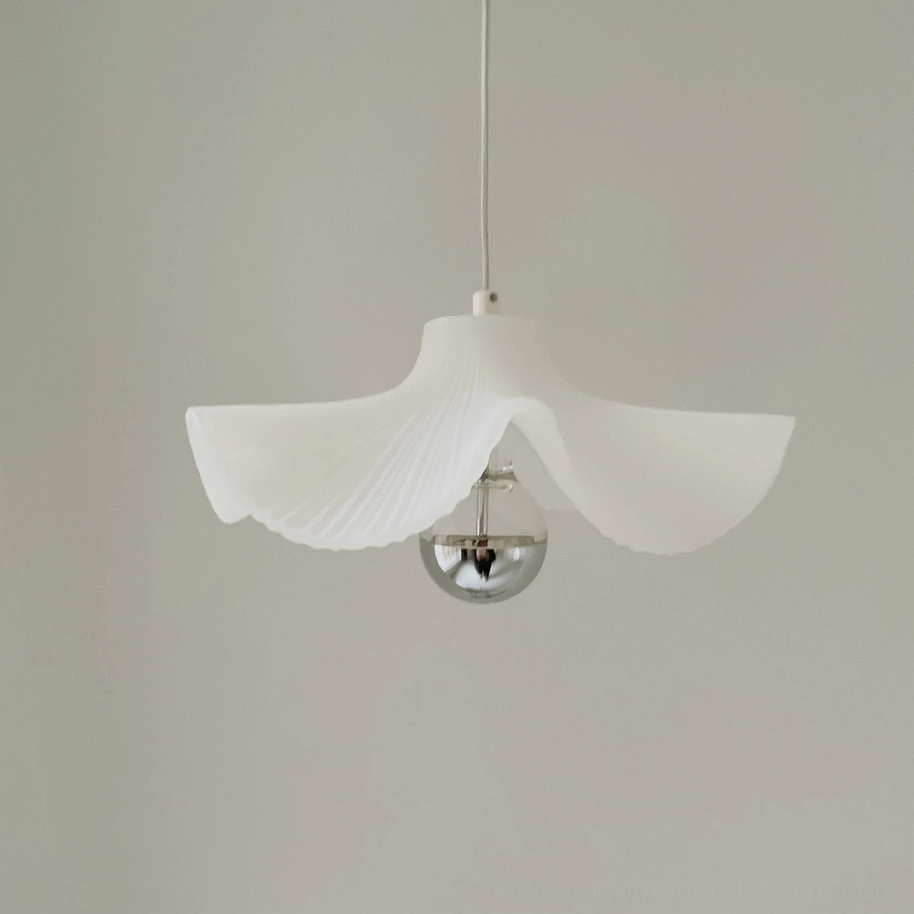 Minimalist pleated pendant fixture with three-color changing light technology