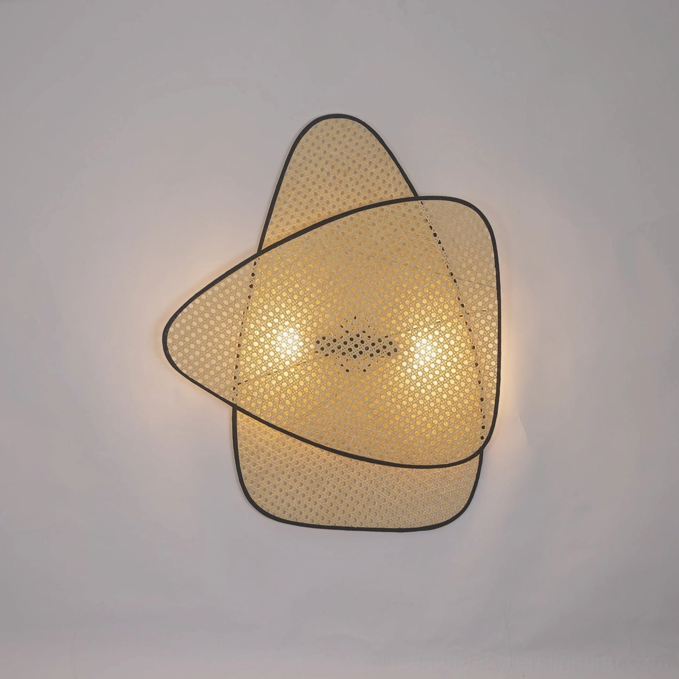 Minimalist woven rattan wall lamp showing clean lines and mid-century modern aesthetic on neutral wall