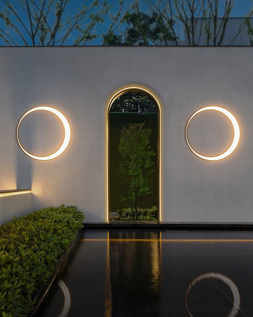 Symmetrical small circular ring lamps on modern courtyard with arched water feature creating tranquil landscape ambiance