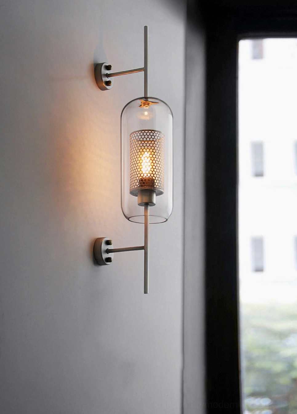 Contemporary glass sconce with minimalist aesthetic and sculptural glass form