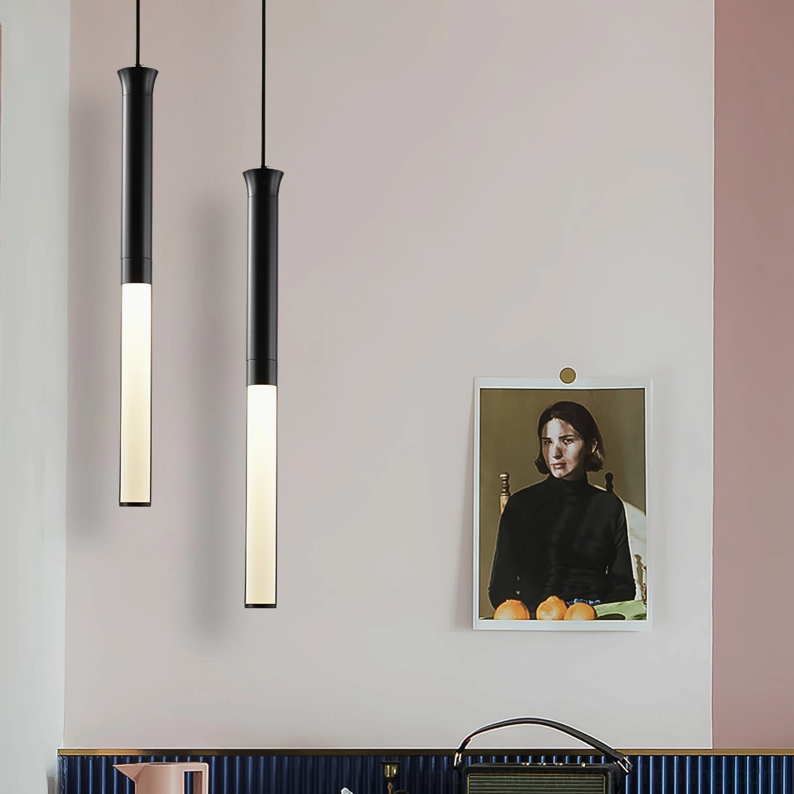 Two Stick LED pendant lights as minimalist wall-mounted decor in modern dining nook with artwork