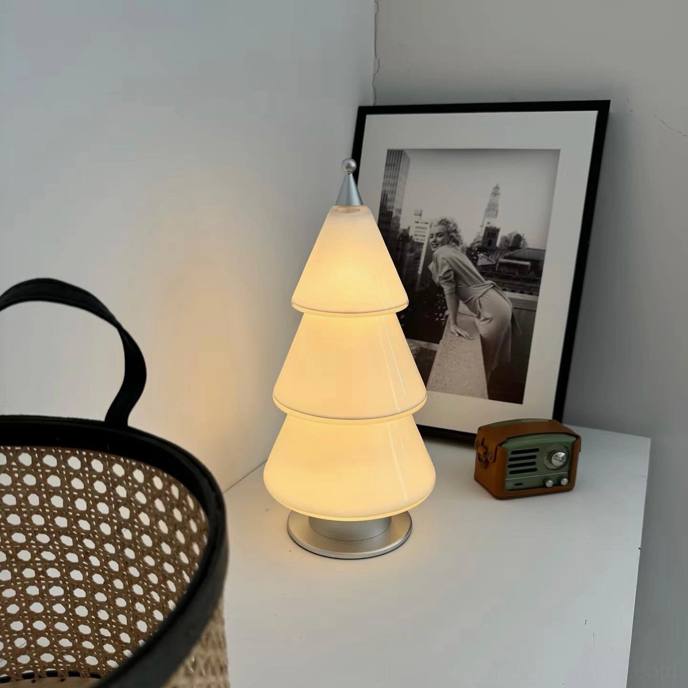 Minimalist modern cone table lamp demonstrating layered tiered shade design and warm ambient lighting effect