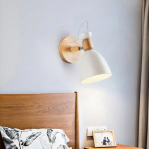 White Nordic wall lamp mounted on bedroom bedside, side profile view showcasing warm ambient lighting and wood accents
