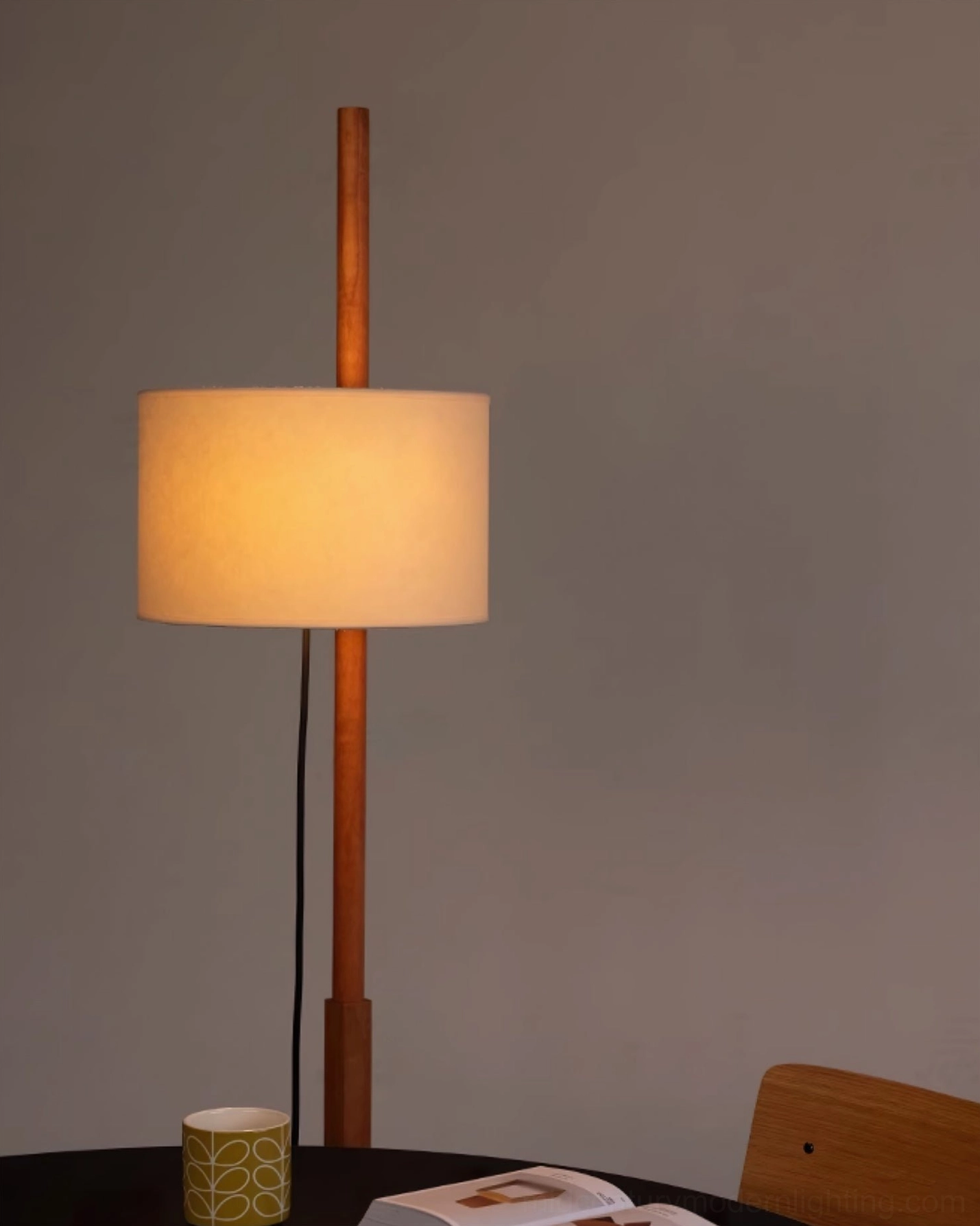 Wooden floor lamp with fabric shade in neutral minimalist room setting