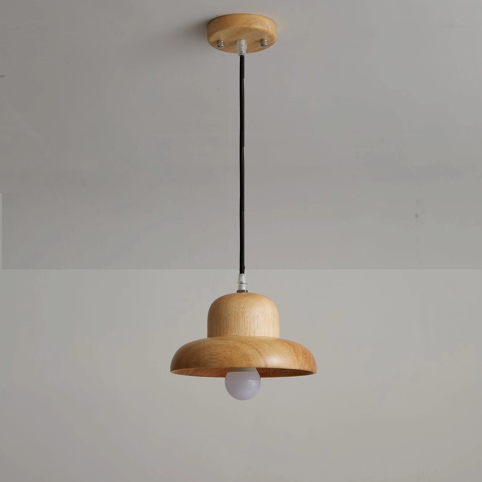 Natural wood pendant lamp suspended in minimalist home environment with clean architectural lines