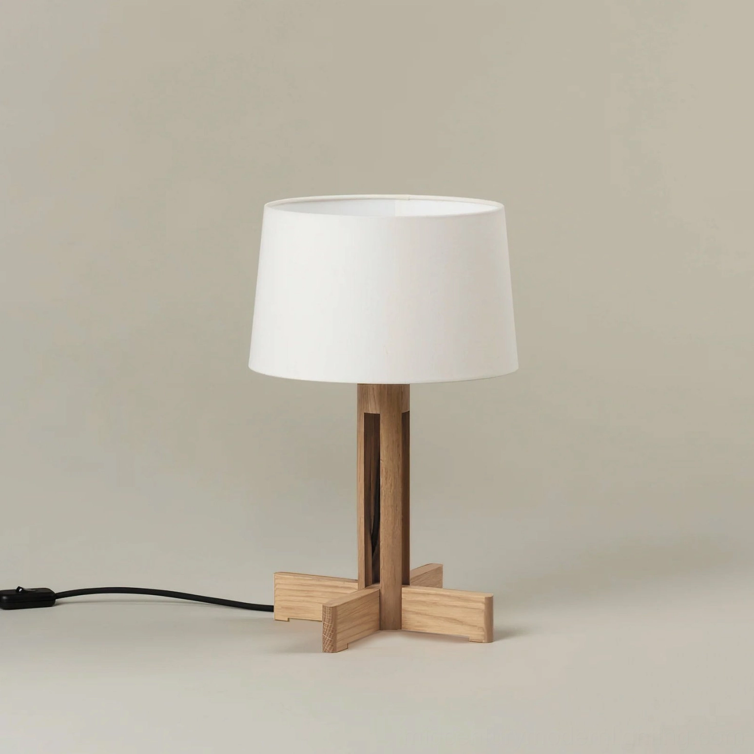 Minimalist wooden table lamp front right angle view with exposed cord, modern studio setting