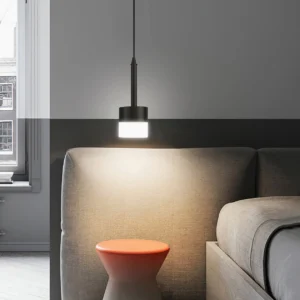 Mira black pendant light hanging in contemporary living room with sofa and warm ambient lighting