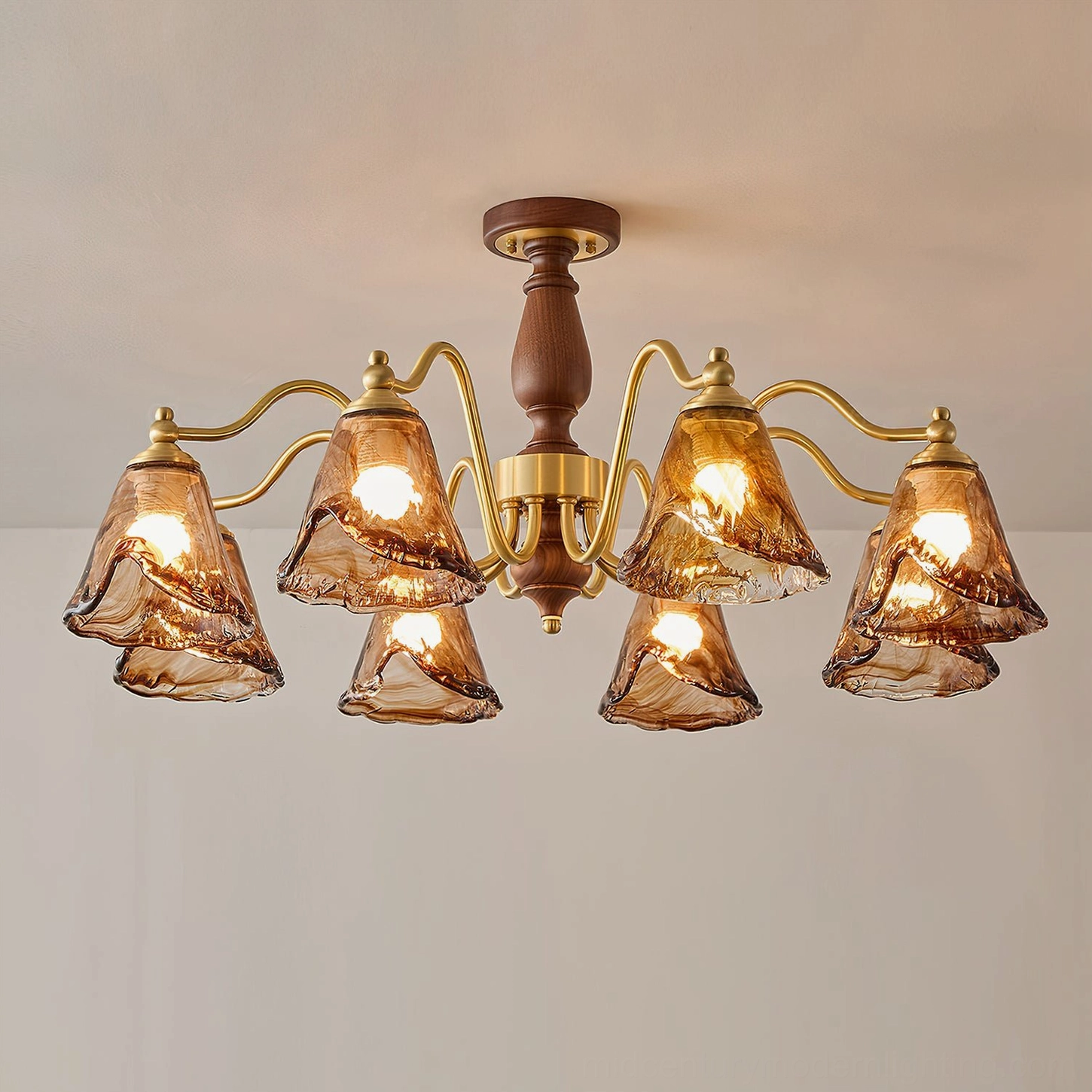 Mirabelle chandelier front flat view showing brushed brass lamp arms and amber glass shades detail against light gray background