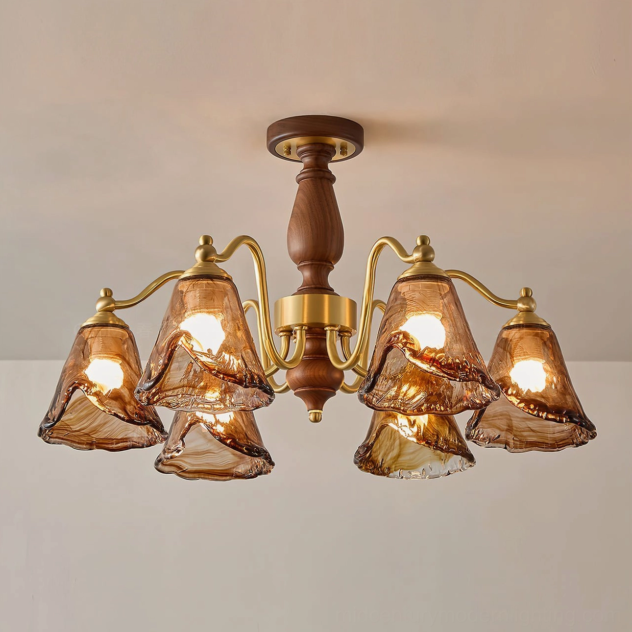 Mirabelle mid-century chandelier fully illuminated displaying warm golden glow through amber glass shades with brushed brass framework lit view