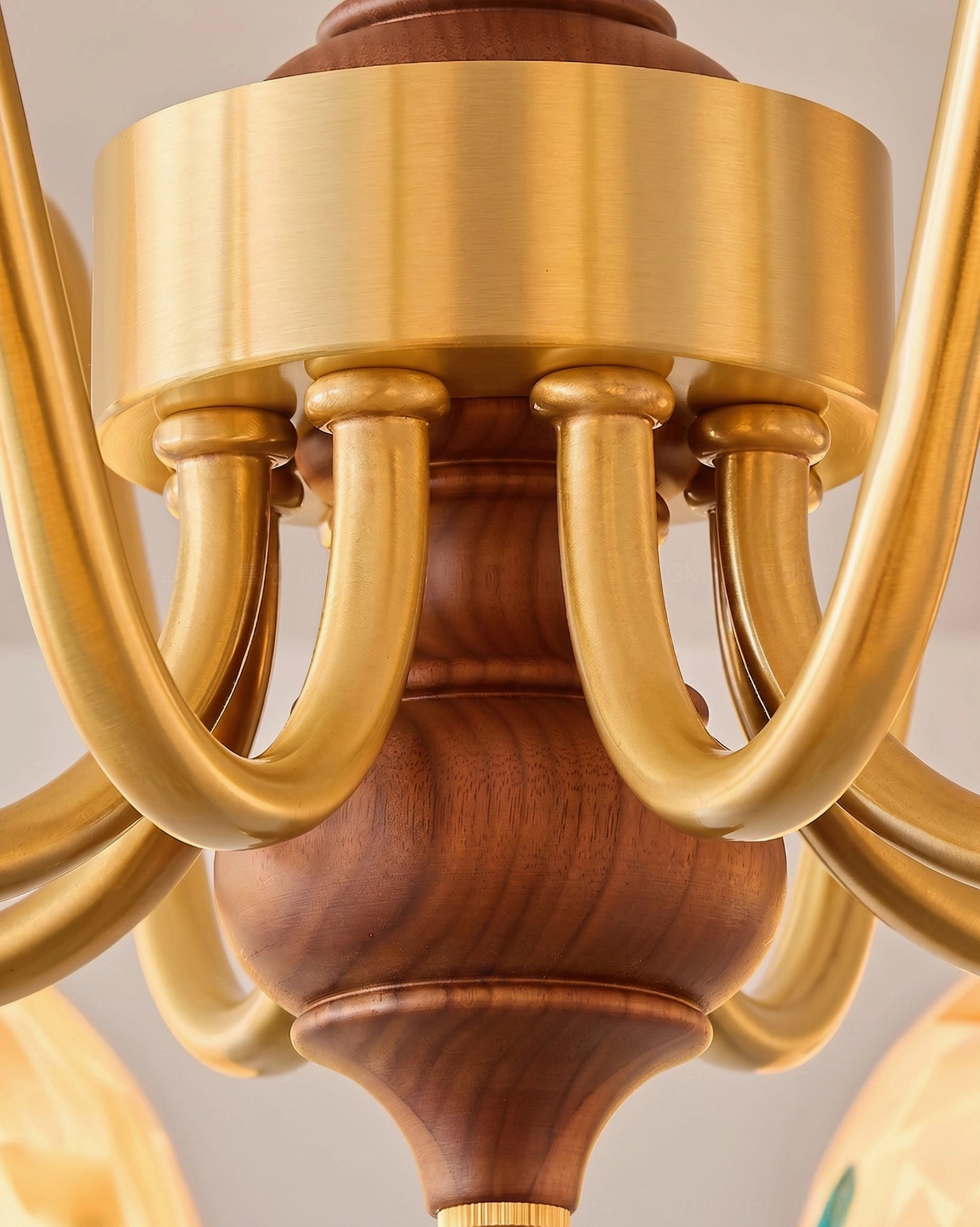 Mirabelle chandelier central pillar and curved brass lamp arms close-up detail showing carved walnut wood and brushed brass craftsmanship