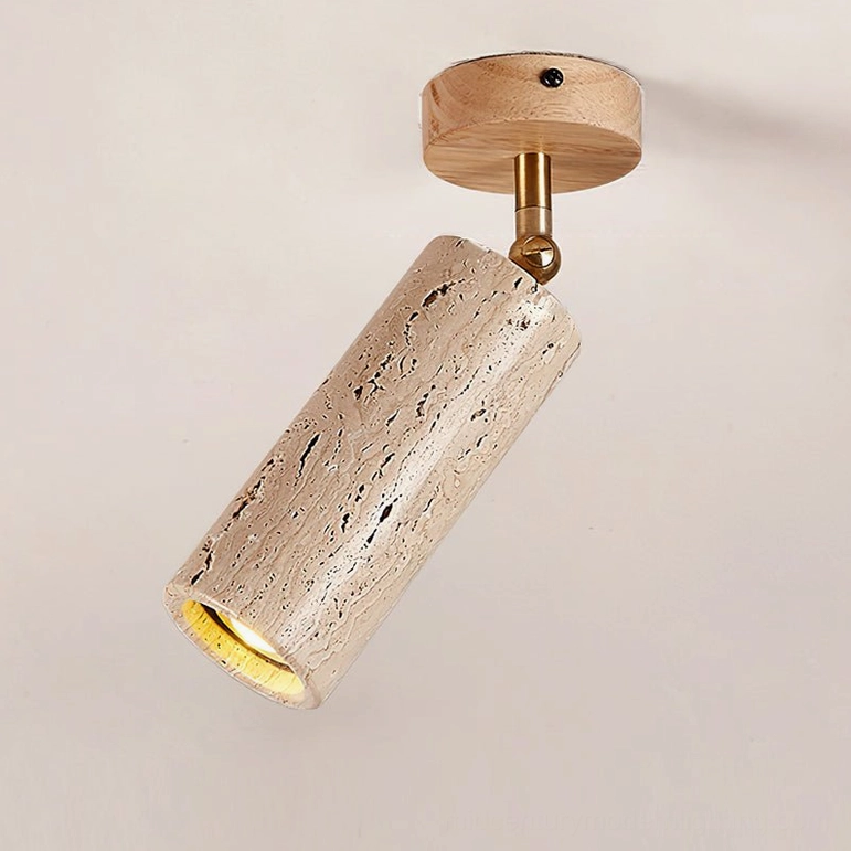 Mireille ceiling light with natural light wood mount and travertine cylinder shade displaying natural stone pores and brass hardware joint