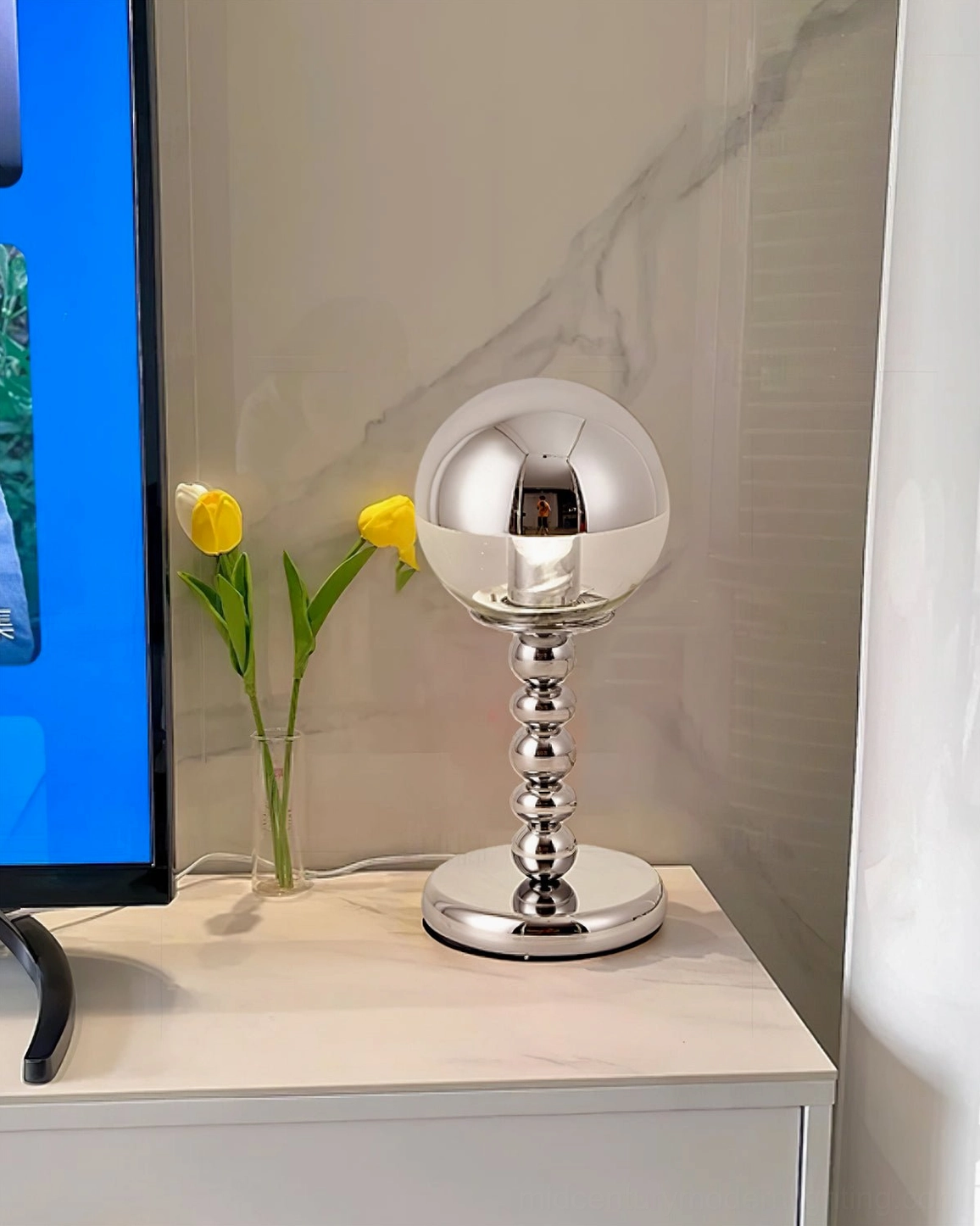 Modern chrome Mirrorball table lamp with geometric sphere shape and polished metal stem detail