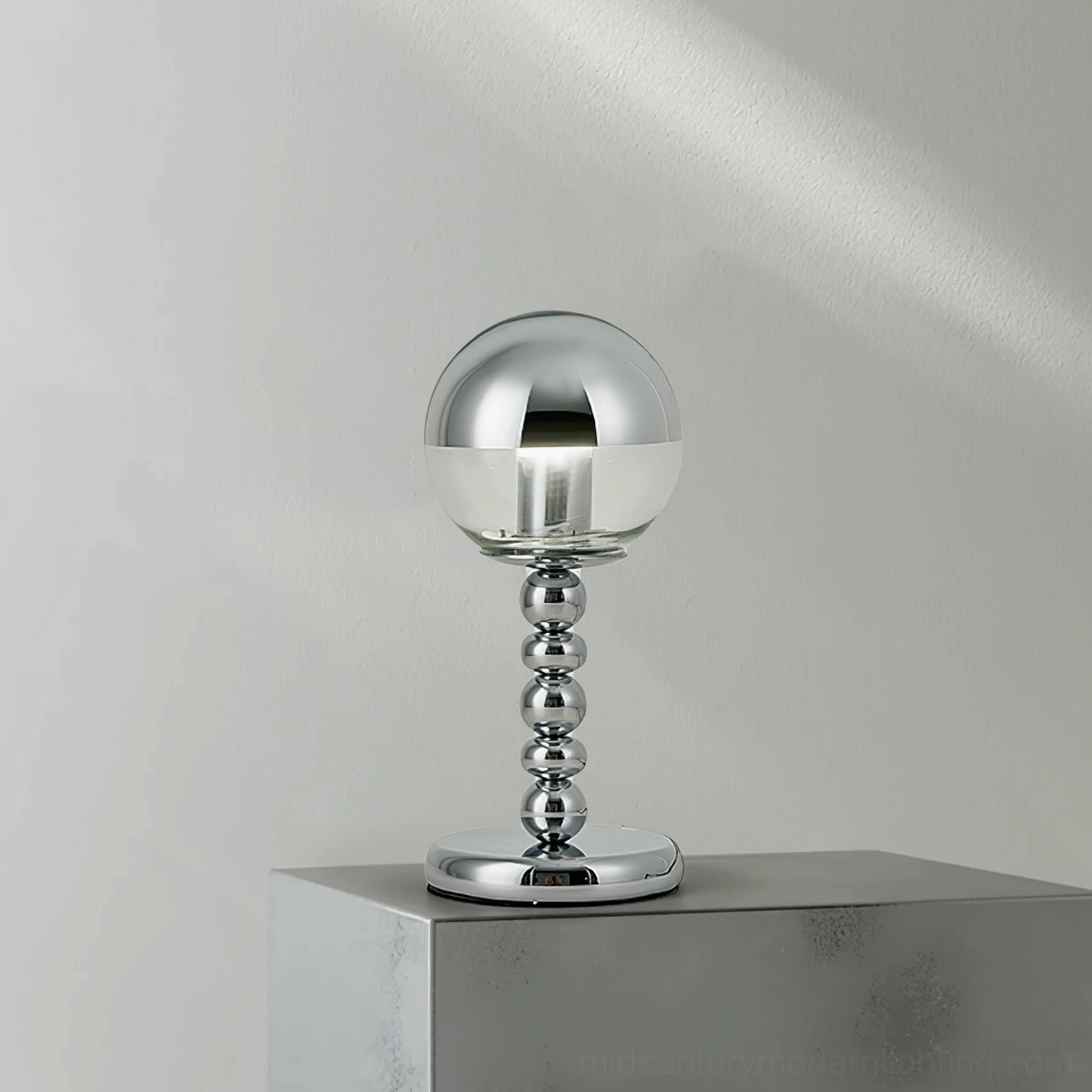 Chrome Mirrorball table lamp with clear and mirrored glass sphere displaying mid-century modern design