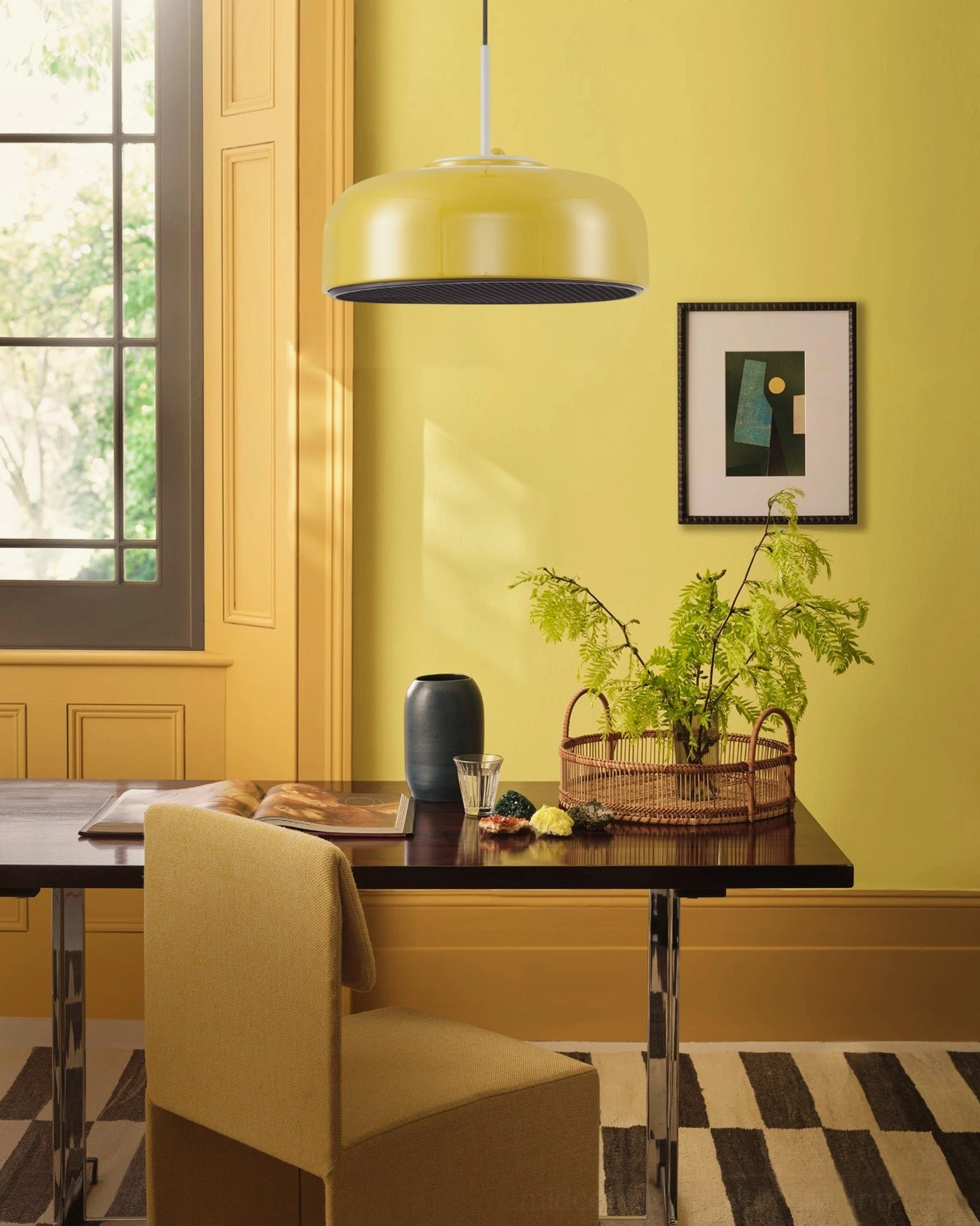 Yellow matte metal dome pendant lamp in dining corner with accent wall and retro aesthetic