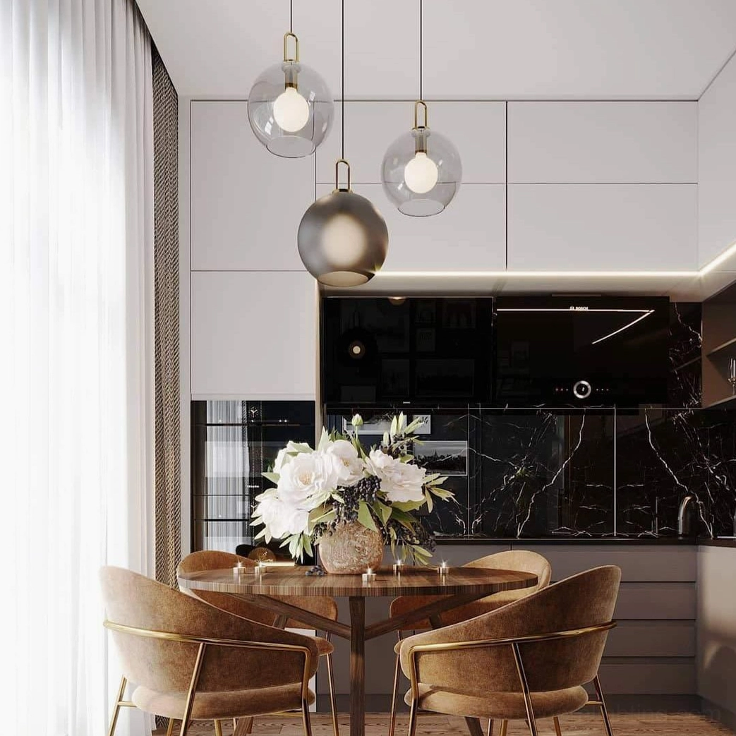 Contemporary kitchen dining space with clear glass and frosted smoke gray spherical pendant lamps, warm ambient lighting